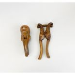 Two carved wooden black forest nut crackers, largest L. 24cm.