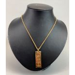 A 9ct gold ingot pendant with 9ct gold rope chain, total weight - 34.5g.