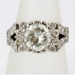 A boxed 18ct white gold (tested) cluster ring set with a large diamond, approx. 2.25ct, surrounded