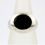 A gent's silver and onyx set signet ring, (O.5).