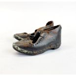 A pair of early child's wood and leather clog shoes, L. 13cm.