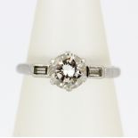 A platinum ring set with a brilliant cut diamond, approx. 0.65ct, with baguette cut diamond set