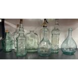 A group of interesting glass bar bottles, tallest H. 32cm.