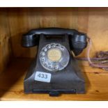 An early brown/black Bakelite telephone.