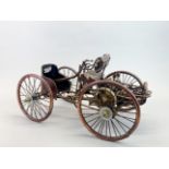 A handmade copper and brass model of an early motor car, L. 38cm H. 19cm.