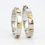 A pair of hallmarked 9ct white and yellow gold hoop earrings, L. 2.5cm.