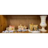 Three handmade pottery cottages, widest W. 23cm, together with an alabaster vase and other items.