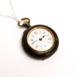 An early 20th C ladies gunmetal and gilt pocket watch, Dia. 3cm. Understood to be in working order.