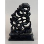 An Oriental carved black soapstone figure of a dragon, H. 16cm.