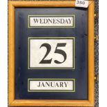 An oak framed wall calendar, 26 x 33cm.