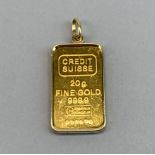 A Swiss 20g fine gold ingot with gold pendant frame.