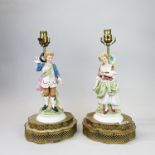 A pair of early 20th C French porcelain and brass table lamp bases, H. 40cm.