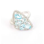 A matching 925 silver ring set with oval cut blue topaz, (O).