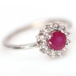 A 925 silver cluster ring set with a rund cut ruby and white stones, (N).