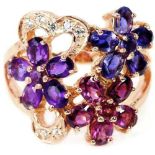 A rose gold on 925 silver flower shaped ring set with amethyst, rodolite garnet and iolite, (N.5).