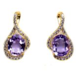 A gold on 925 silver earrings set with oval cut amethysts and white stones, L. 2.5cm.