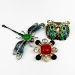 Two enamelled brooches and one other (pin missing on orange centre brooch), dragonfly W. 9cm.