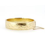 A heavy hallmarked 9ct yellow gold bangle, L. 6.3cm.