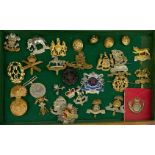 A box of military cap badges and buttons.