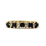A hallmarked 9ct yellow gold half eternity ring set with round cut sapphires and diamonds, (L.5).
