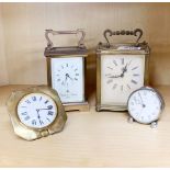 Two brass carriage clocks, a brass travelling clock and a vintage alarm clock.