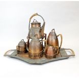 A hammered Sessessionist copper tea set. Spirit kettle overall H. 34cm, tray L. 55cm.