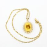A hallmarked 9ct yellow gold locket pendant and 9ct yellow gold chain, L. 54cm.