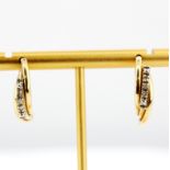 A pair of 9ct yellow and white gold diamond set half hoop earrings, L. 2cm.