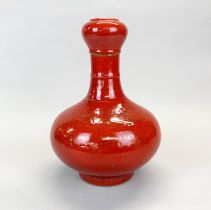 A red glazed garlic topped Chinese porcelain vase, H. 31cm.