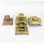 Four brass inkwells, tallest H. 13cm.