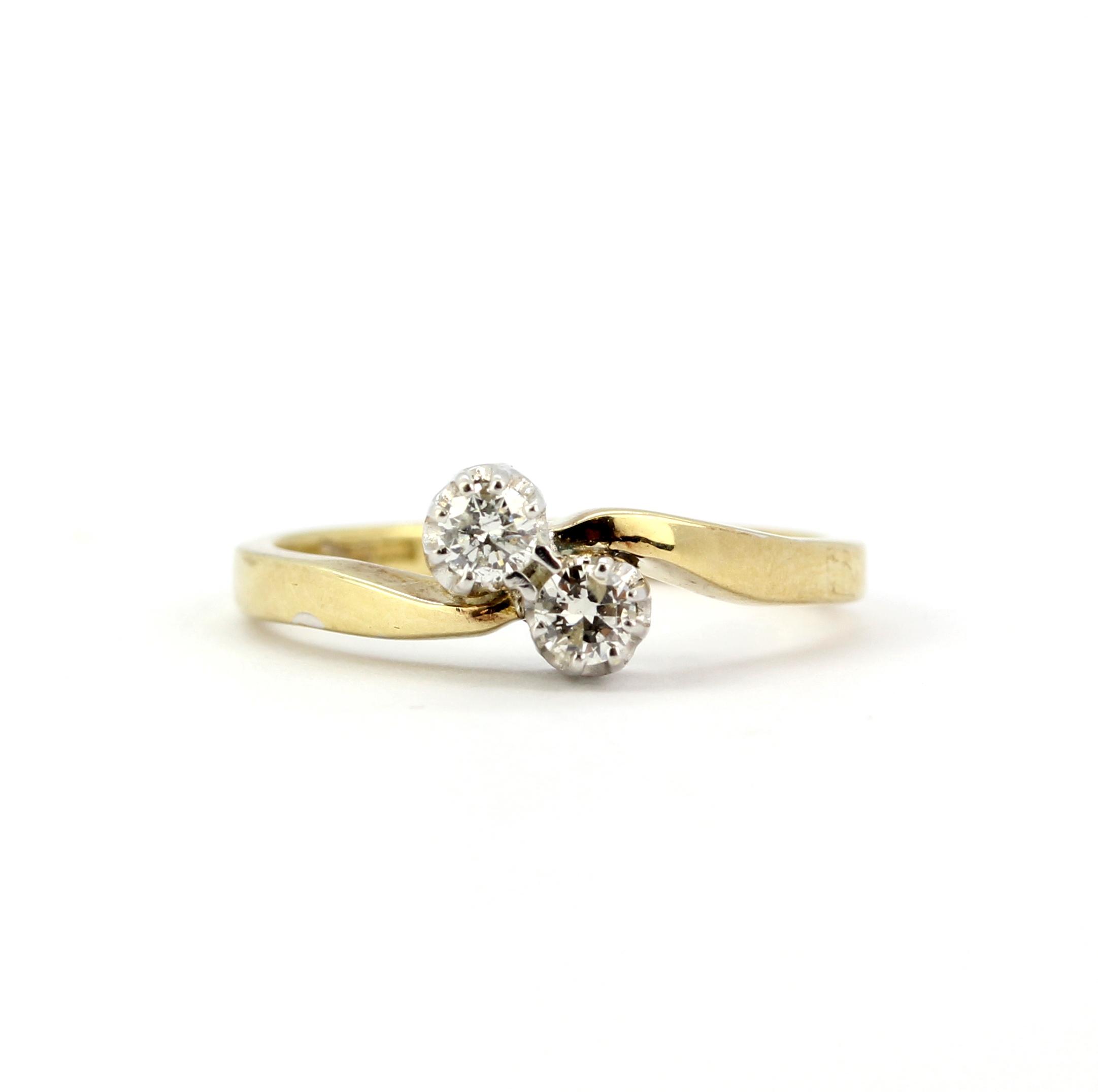 A hallmarked 9ct yellow gold crossover ring set with two brilliant cut diamonds, approx. 0.20ct