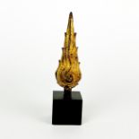 A Siamese gilt bronze Buddhist flame mounted on a black base, H. 10.5cm.