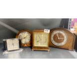 A Mappin and Webb mantel clock with two further oak mantel clocks and an Art Deco alarm clock,