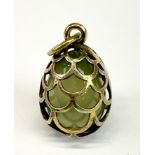 A gilt white metal (tested silver) and jade egg pendant, probably Russian, L. 2.5cm.