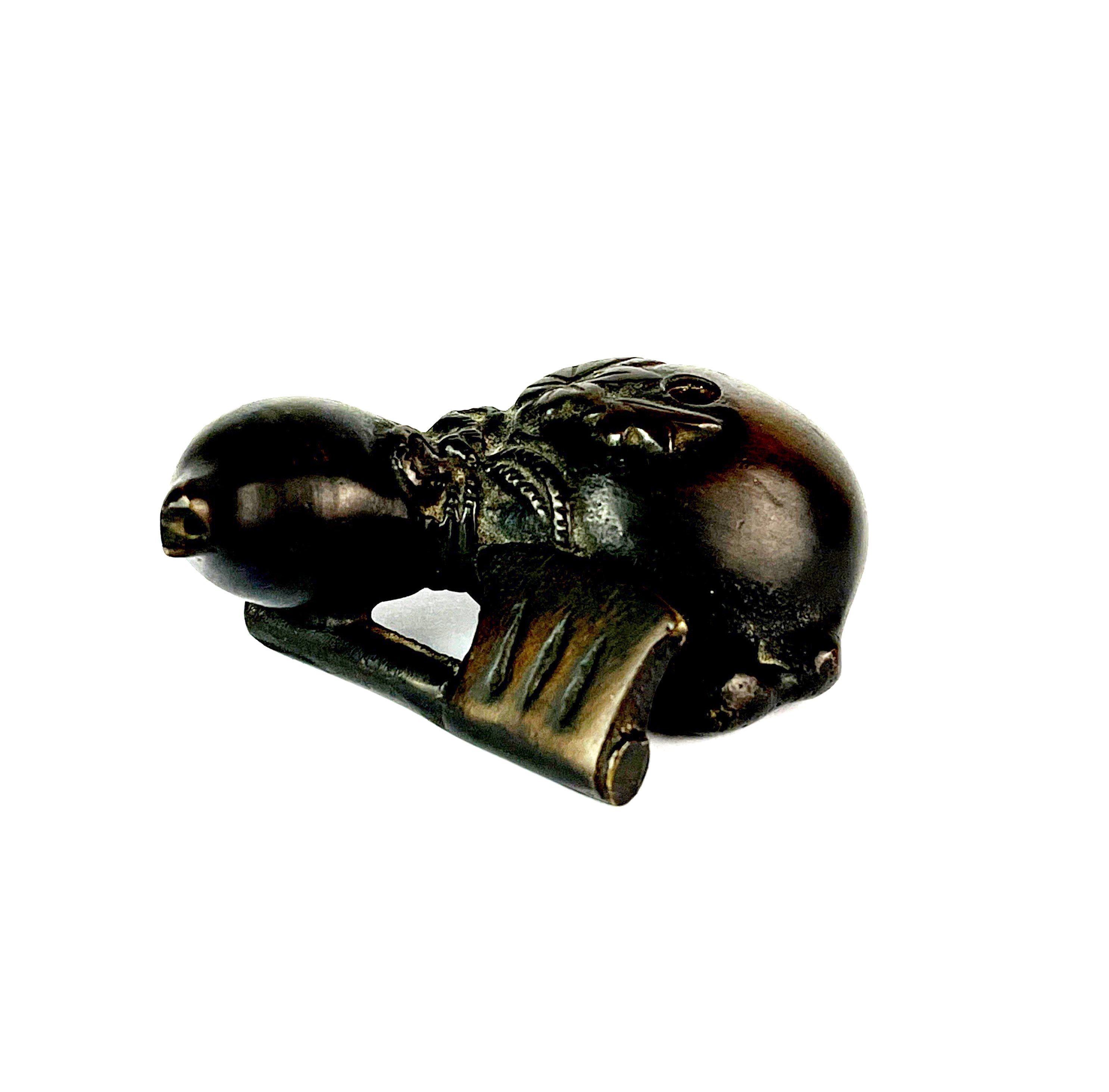 An unusual small Chinese bronze water dropper of a gourd with an axe, L. 6cm, H. 2.5cm.