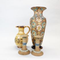 A Royal Doulton stoneware vase, a pair of Royal Doulton candlesticks and a puzzle jug with