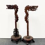 Two mid 20th C Chinese carved wooden dragon lamps, H. 70cm.