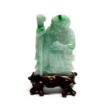 A Chinese carved jade figure of Shou Lao with carved wooden stand, overall H. 9cm.