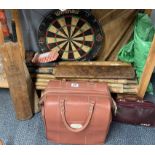 A group of cricket bats, stumps and other sporting items.