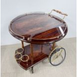 A vintage wooden drinks trolley with gilt rail and wheels, L. 78cm H. 74cm.