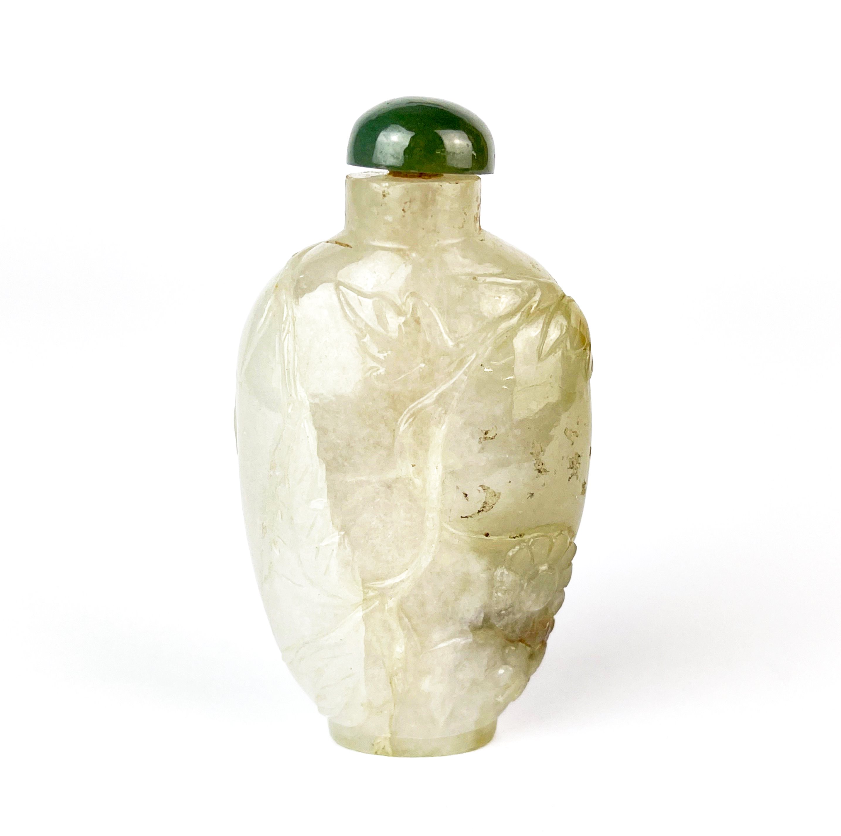 A Chinese carved mixed colour jade snuff bottle decorated with flowers and foliage, H. 7.5cm. - Image 2 of 2