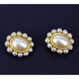 A large pair of Chanel clip on earrings set with faux pearls, L. 4.3cm. Some minor damage to