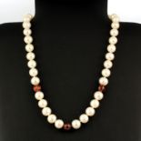 A cultured pearl necklace, pearl size approx. 0.5mm, with three enamel and diamond set beads and
