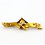 A yellow metal brooch set with old cut diamonds, center stone approx. 0.20ct, L. 5.2cm. Three