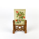 A miniature Chinese jade table screen set with semi precious stones in a carved wooden frame, H.