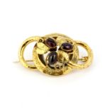 A Victorian yellow metal (tested minimum 9ct gold) brooch set with oval cabochon cut garnets, L.