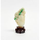 A Chinese carved jade model of a vase with peaches on a carved wooden stand, overall H. 10cm.