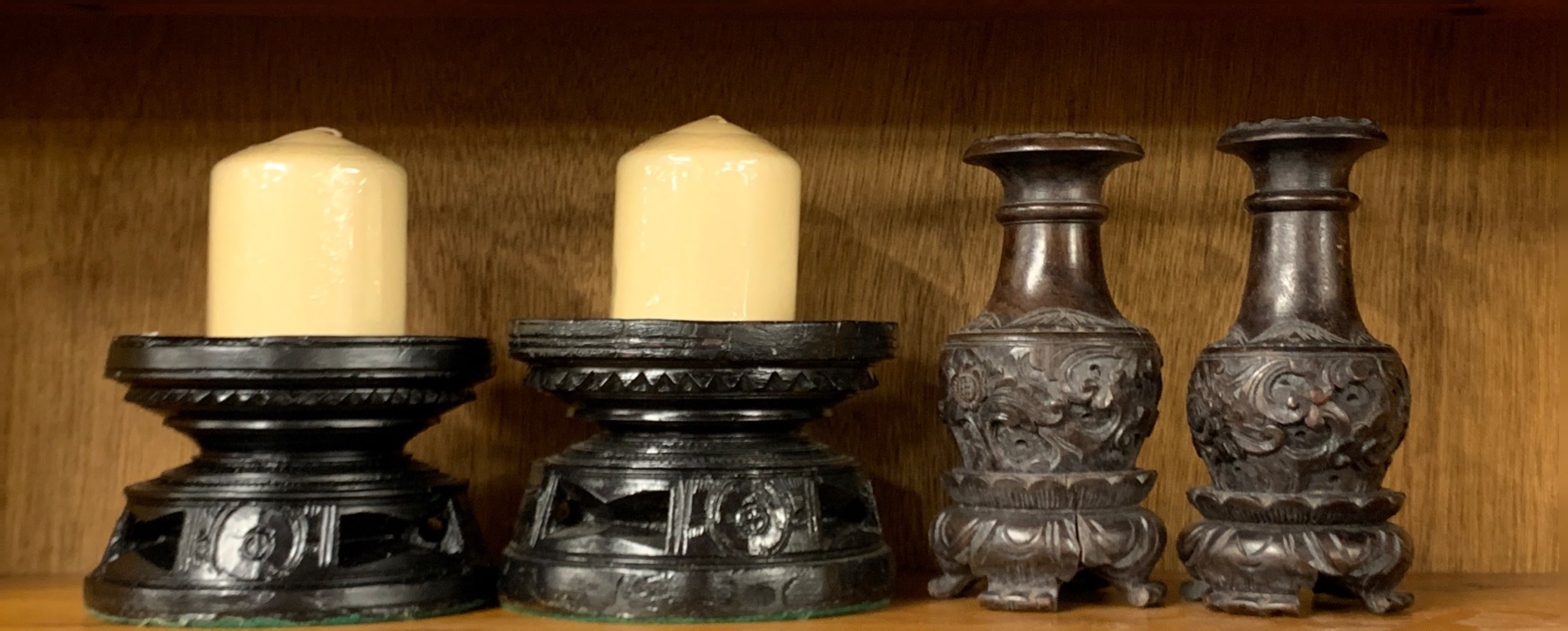 Two pairs of carved eastern hardwood candlesticks, H. 17cm.