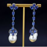 A large pair of white metal drop earrings set with oval cut sapphires, diamonds and large baroque