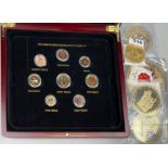 A group of gilt and enamelled British commemorative coins together with a box of enamelled British